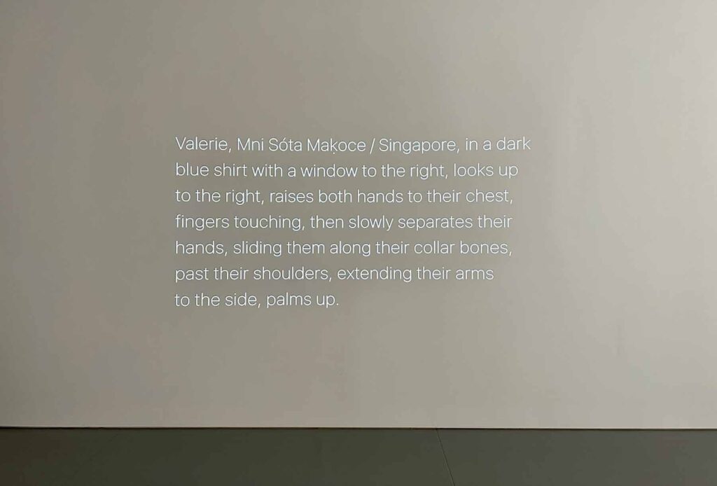 Written description of a physical gesture projected on a wall. The Dis/Agreement Project.